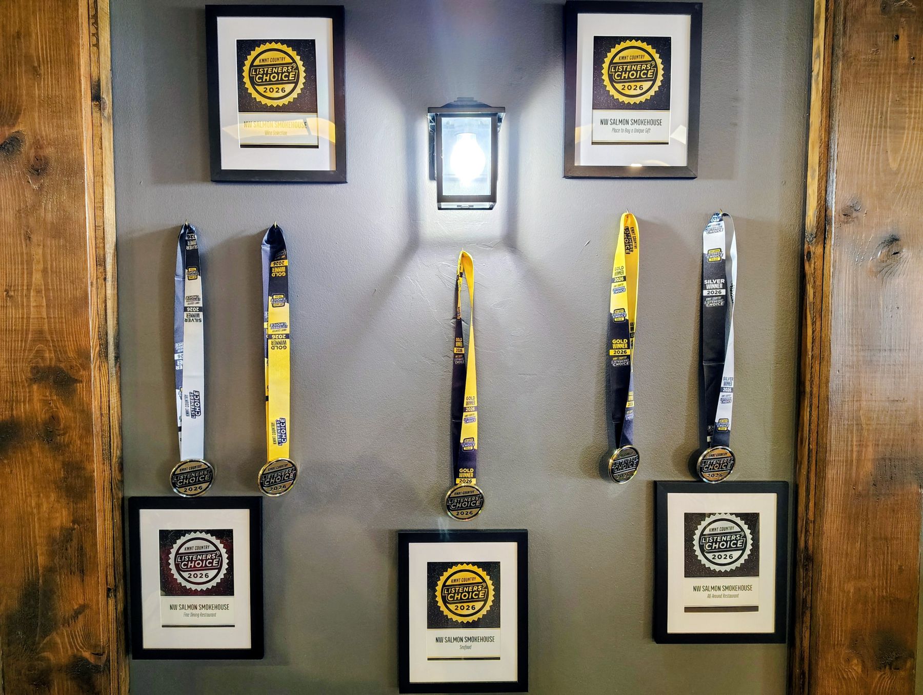 The award wall: KMNT Listeners' Choice 2026 frames and medals