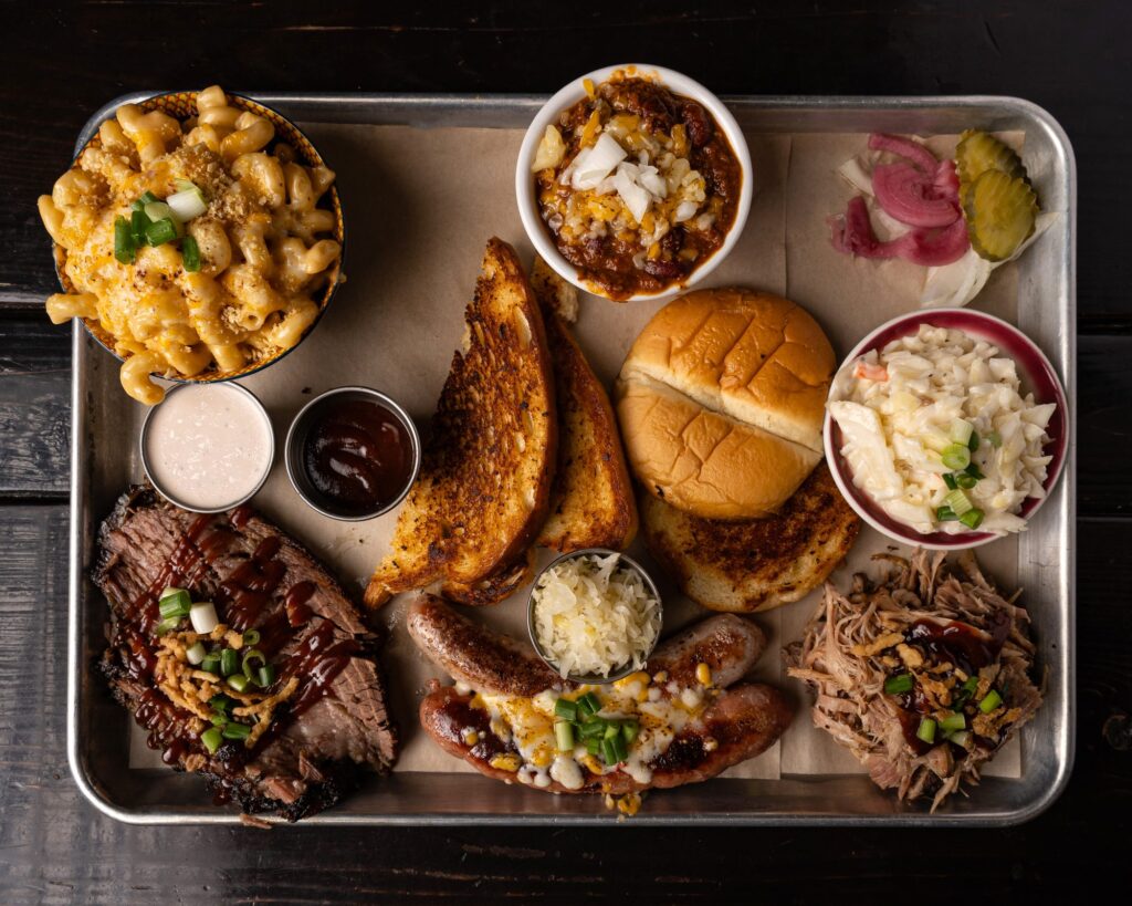 BBQ combo platter with sliced brisket, pulled pork, smoked sausage, mac and cheese, coleslaw and Texas toast