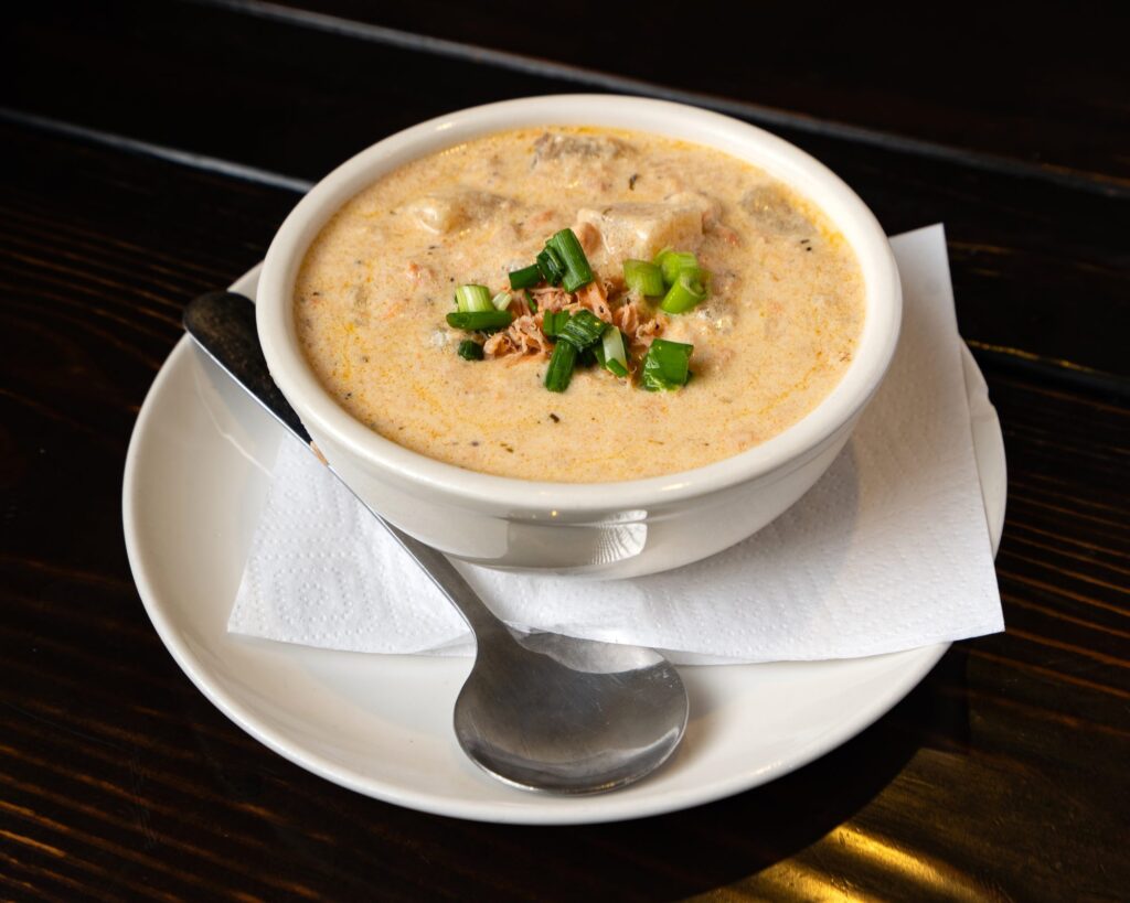 Bowl of smoked salmon chowder with green onion