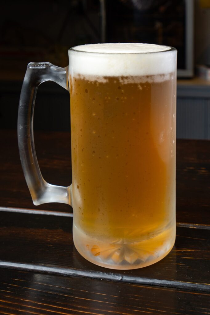Frosted mug of cold beer on the table