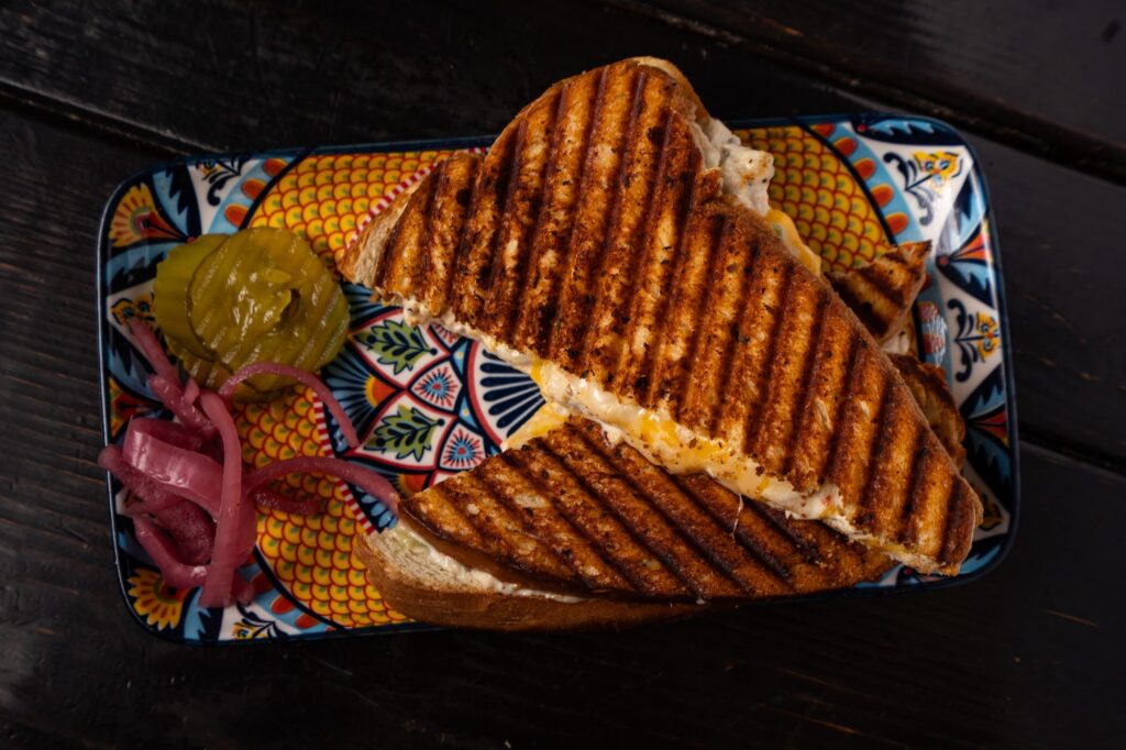 Grilled cheese sandwich with pickles and pickled red onion