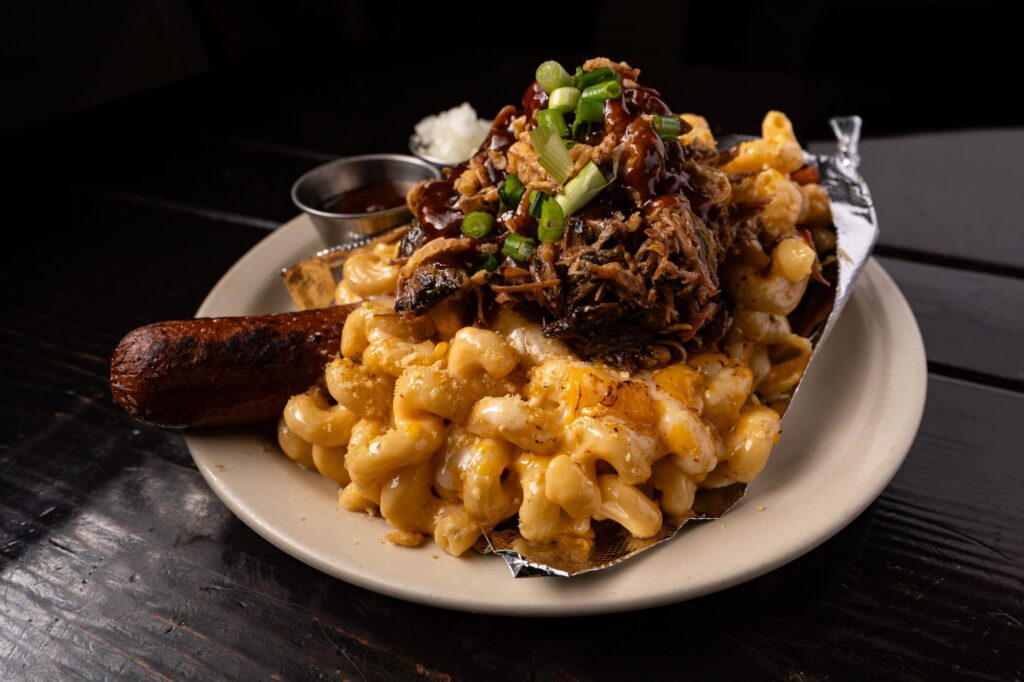 Pulled pork over smoked mac and cheese with a smoked sausage