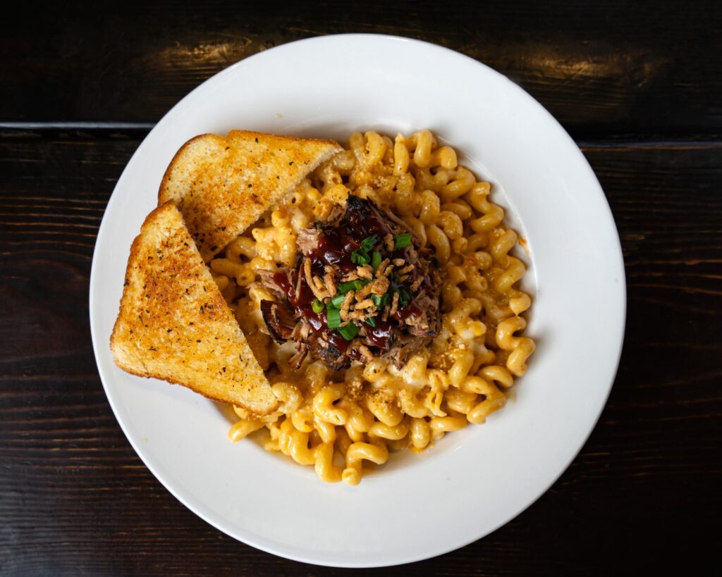 Pulled pork over smoked mac and cheese with garlic toast