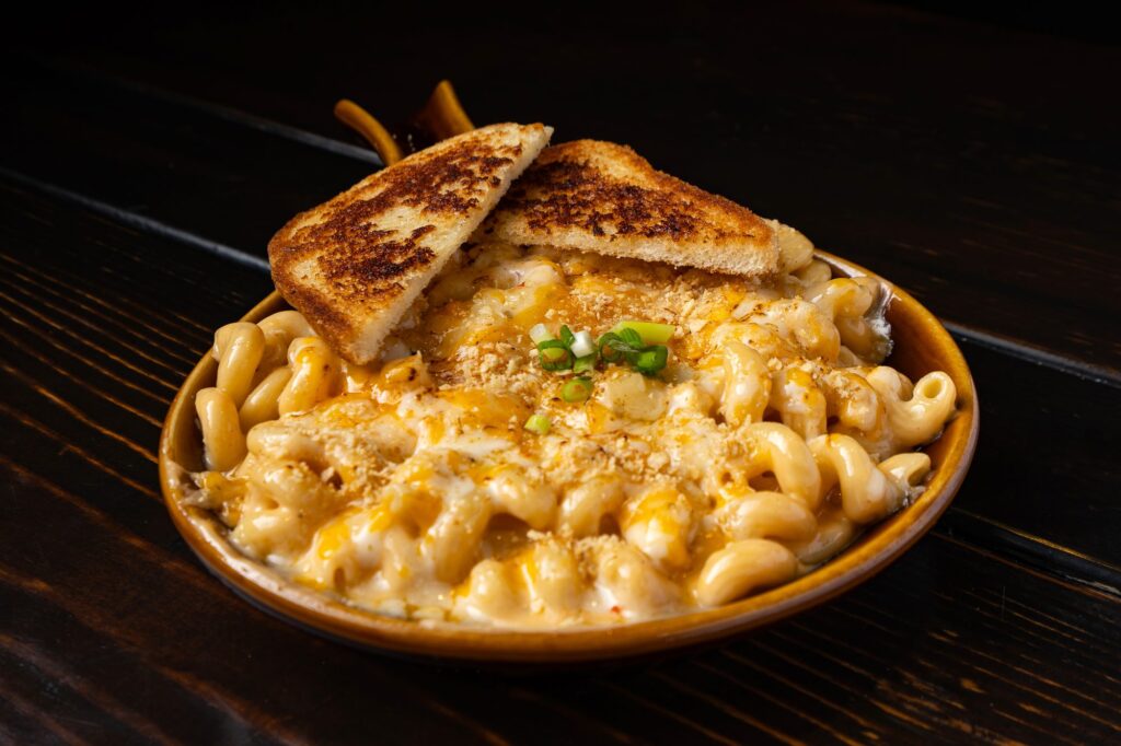 Smoked mac and cheese topped with grilled cheese wedges