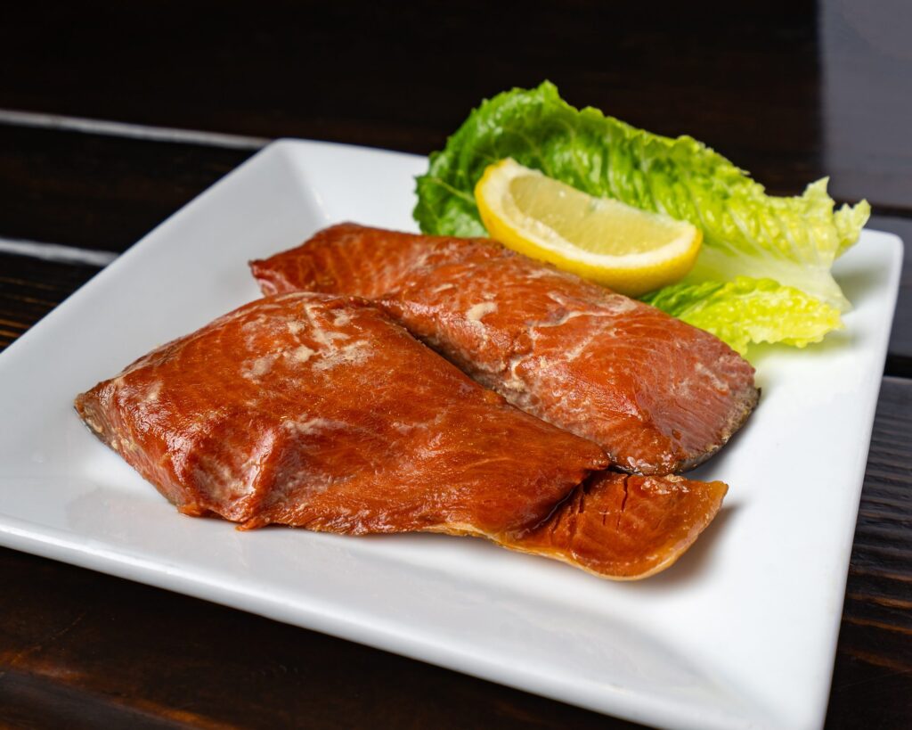 Two fillets of wild-caught smoked salmon with lemon and romaine